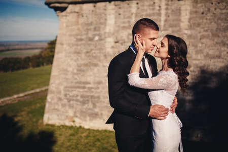 Handsome groom and his cute bride on the old balcony. wedding photography.の写真素材