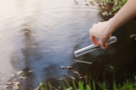 A water sample from the river. Water intake. Water abstraction. sample water. the concept of a clean environment.の写真素材