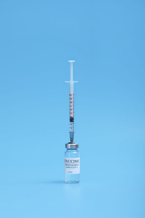 Medicine bottle with coronavirus vaccine covid-19. Medical glass vial and syringe for vaccination....