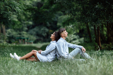 Young couple is hugging and walking near the lake on sunny day. Man and woman on summer holiday. Concept of lovely family. selective focus.の写真素材
