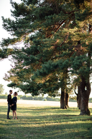 young couple in love having fun and enjoying the beautiful summer nature. woman and man, wearing in denim outfit are having date outdoors in the park. Romantic relationship. valentines dayの写真素材