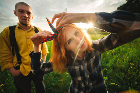 The bride and groom go through the forest hand in hand. Happy bride and groom holding hands and walking in forest on wedding dayの写真素材