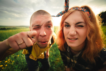 Playful happy handsome couple having while walking in woods. tourists in the mountains. Adventure in...