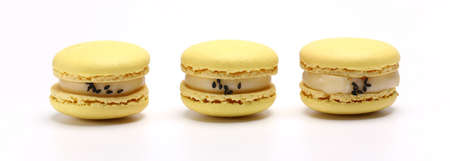 three cake of macaron or macaroon yellow lemon color. Delicious macaroon isolated on white background. French sweet cookieの写真素材