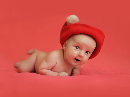 cute smiling naked little baby boy in santa hat on pink background. copy space. christmas holiday conceptの写真素材
