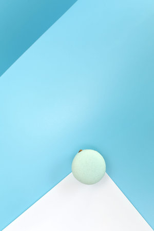 Tasty blue french macaron or macaroon on a white and blue background. Place for text. color...