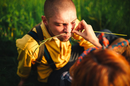 Loving hipster couple walking in the field, kissing and holding hands, hugging, lying in the grass...