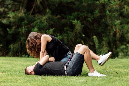 Smiling couple having fun in the park. Love and tenderness, dating, romance, lovers enjoy each other...
