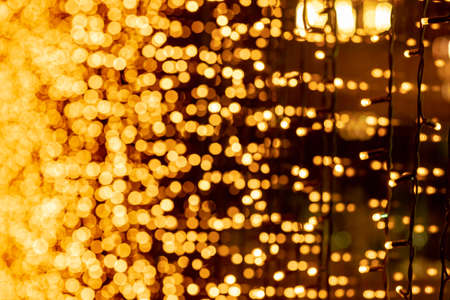 Abstract circular bokeh background of Christmaslight. bokeh from garlands. background for screensaver. Defocused lights. Blurred bokeh with yellow color lightsの写真素材