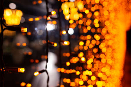 Abstract circular bokeh background of Christmaslight. bokeh from garlands. background for screensaver. Defocused lights. Blurred bokeh with yellow color lightsの写真素材