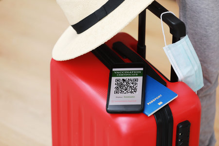 New normal concept. Close up view of a smartphone with an immune digital health passport, a red...