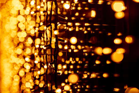 Abstract circular bokeh background of Christmaslight. bokeh from garlands. background for screensaver. Defocused lights. Blurred bokeh with yellow color lightsの写真素材