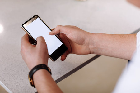 Close up of mans hands holding cell telephone with blank copy space scree for your advertising text...