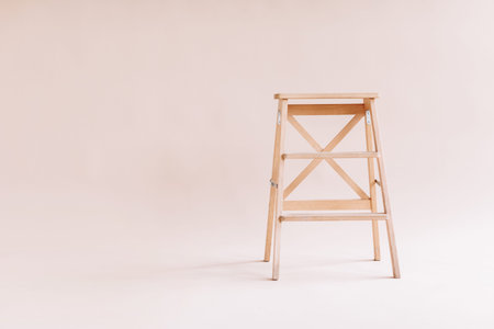 New wooden ladder on the white background. isolated stepladder. Space for text.