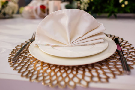 Elegant and chic gold and white table setting. selective focus.の写真素材