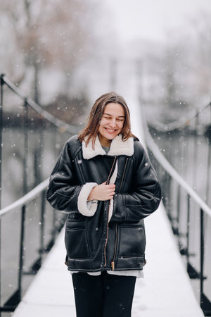 Studio portrait of attractive young woman with dark hair in white shirt and red pants sitting on classic chair on plain white background. Bossy female, job interview concept, confident independent lady.の写真素材
