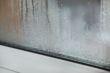 a plastic window with condensation of water on the glass. Double glazed PVC window. Concept:...