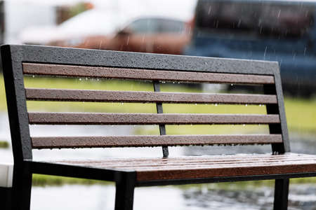 wooden with metal bench under the rain outdoors. High quality photo.の写真素材
