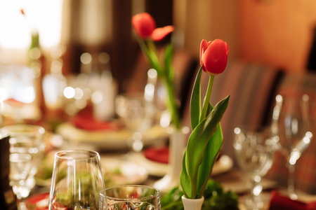 festive table set for the holiday with tulips flowers. High quality photo.の写真素材