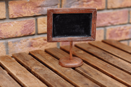 Empty wooden plate on wooden table in a restaurant, copy space for example reserved. High quality...
