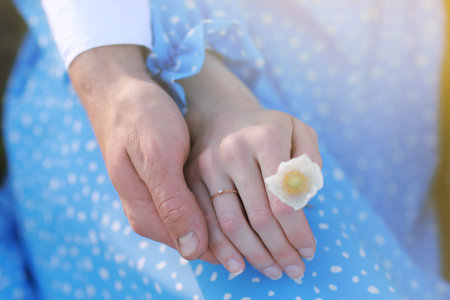 romantic date concept. young man and woman hands holding each other. girl with golden ring on finger...