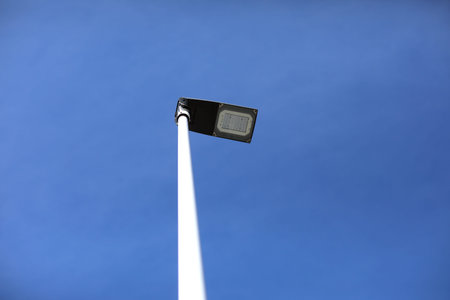 Modern street lighting against blue sky - bottom view - horizontal image. High quality photo.
