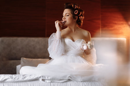 beauty concept. portrait of a beautiful young showy brunette woman with bright pin-up make-up in pink curlers. Studio Shot Cropped. facial treatment. Cosmetology, skin care and spa.の写真素材