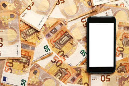 smartphone with blank display mockup screen on 50 euro banknotes. money paper. Concept of business, investment and income growth.Modern technology, communication and online trade using gadget conceptの写真素材