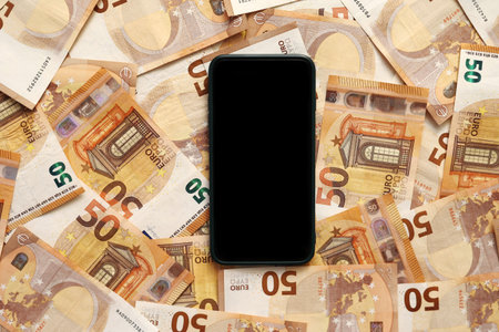 smartphone with blank display mockup screen on 50 euro banknotes. Modern technology, communication...