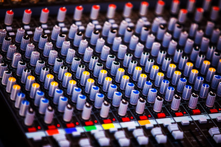 Concert sound mixer panel with volume regulators. Professional audio and light equipment for sound...