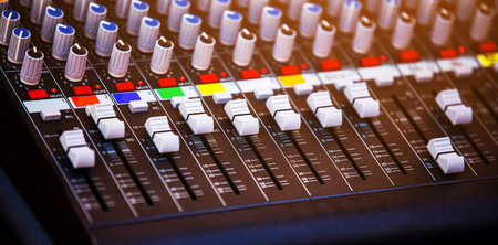 Concert sound mixer panel with volume regulators. Professional audio and light equipment for sound...