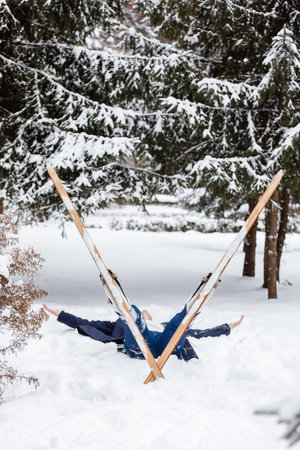 Beautiful cold forest view and skier wearing in skis that lying and relaxing after skiing. Winter...