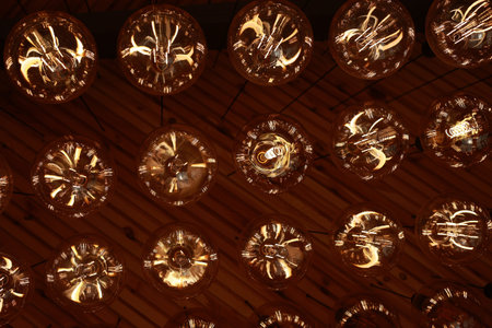 Stylish, modern and decorative lamps of Edison of round shape in the rows. Light bulbs in retro...