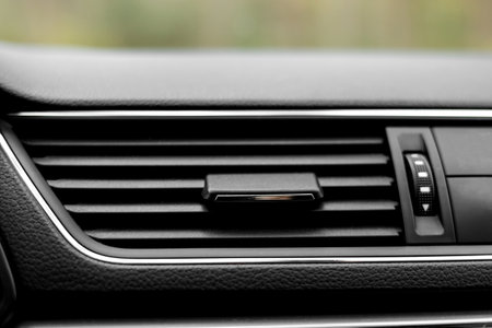 Air conditioner flow inside the car, plastic grid panel. Vehicle air conditioning close up view. Detail interior of modern car. air ducts. Dashboard.の写真素材