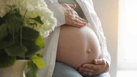 Pregnant woman's belly. Pregnant woman touching caressing her belly. Healthy Pregnancy Maternity Motherhood concept. Mother hands on pregnant tummy. waiting for baby, Happy family, expecting baby.の写真素材