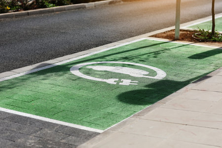 Special place for charging electric cars or vehicles. Green E- Car charging station sign in a parking bay. Modern and eco-friendly mode of transport that has become widespread in Europe, Spainの写真素材