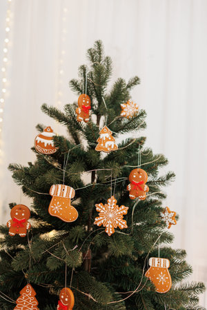 Beautiful Christmas tree decorated traditional homemade gingerbread men, snowflakes, boots and balls...