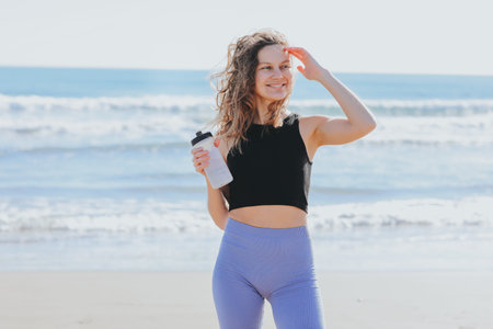 Fitness, sport and healthy active lifestyle. Happy slim young athlete lady in sportswear holds...