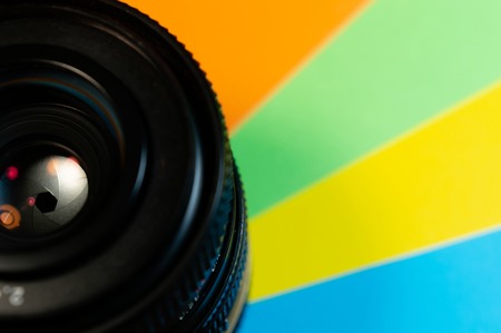 Lens with closed aperture and glows on colored backgroundの写真素材