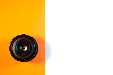Lens with closed aperture on orange and white background isolatedの写真素材