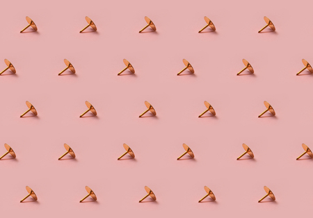 Golden tack pattern on pink background horizontal linesの写真素材