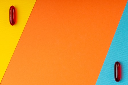 Pills and pattern with orange background with blue and yellow elementsの写真素材