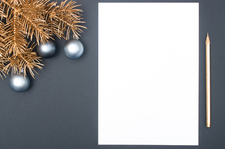 Golden Christmas tree branches decorated with baubles and golden pencil with copy space isolatedの写真素材