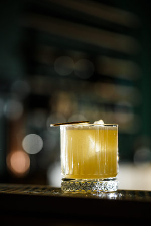 Fruit mixology with mezcal and dry lime on black marble background. Warm colored cocktails. Mezcal cocktailの写真素材