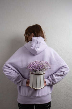 Baby's Breath pink flowers box. Gift flowers in white box. Woman holding a flower box with gypsophilaの写真素材