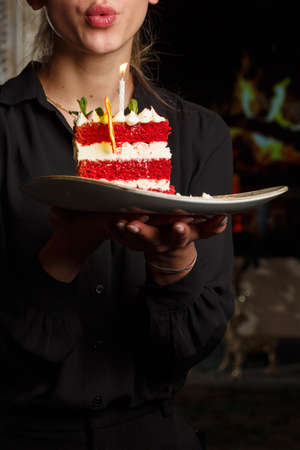 Girl with Slice of delicious homemade red velvet cake with raspberry and chocolate. Copy space for textの写真素材