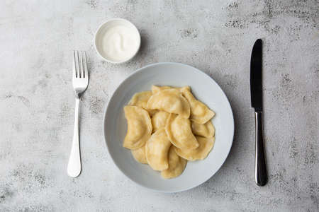 Traditional ukrainian dish vareniki served in a bowl with sour cream. Close up view of traditional Ukrainian foodの写真素材