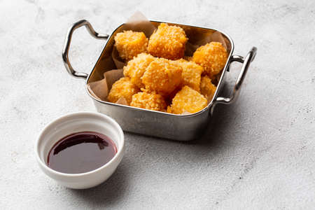 Deep fried Cheese squares served with cranberry sauce in marble background. Delicious homemade appetizerの写真素材