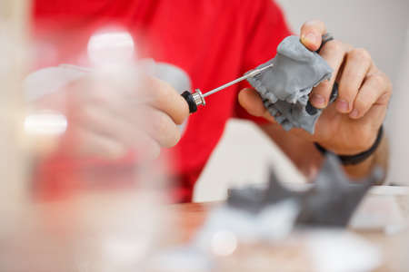 Dentist practice with mini screw model on dental model. Orthodontic dentistry. False teeth.の写真素材