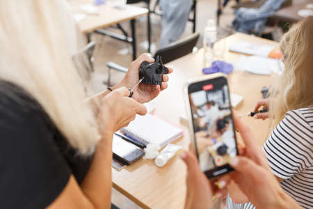 Dentist taking photo of 3d dental model on the table. Dental model with mini screw. Orthodontic dentistry. False teeth.の写真素材